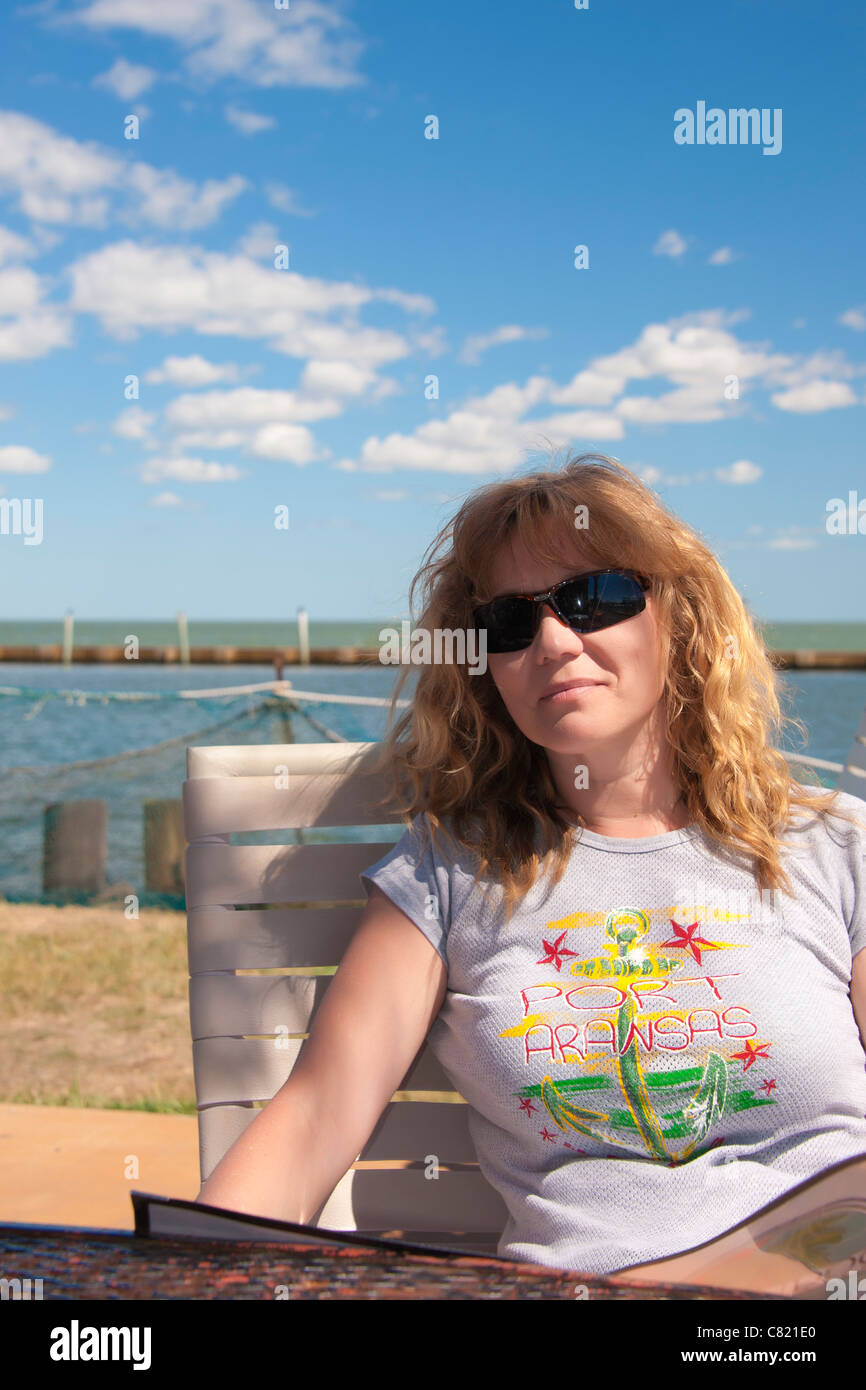 Woman sitting in an outdoor restaurant at the sea Stock Photo