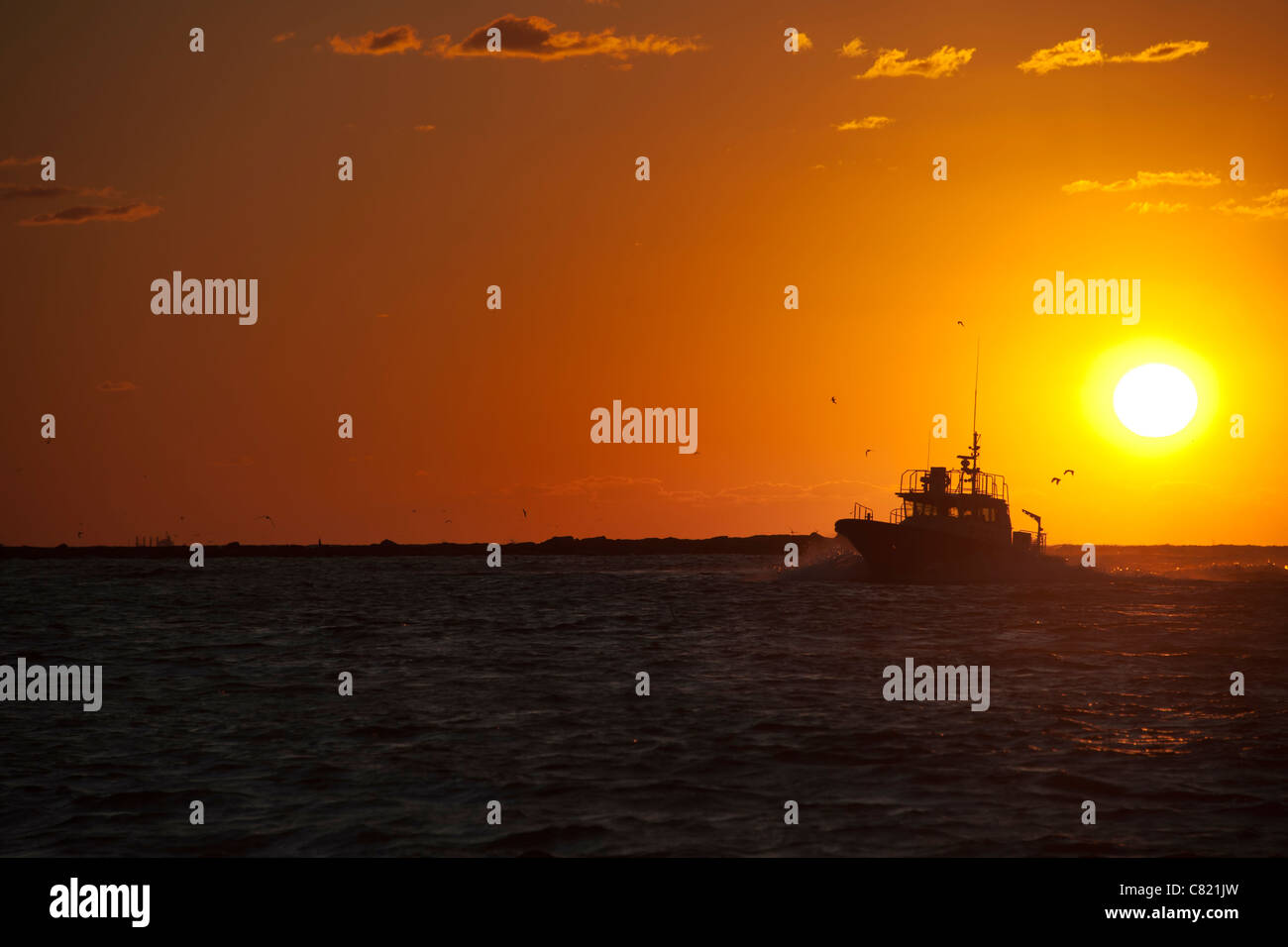 Fishing boat in sunset sea hi-res stock photography and images - Alamy