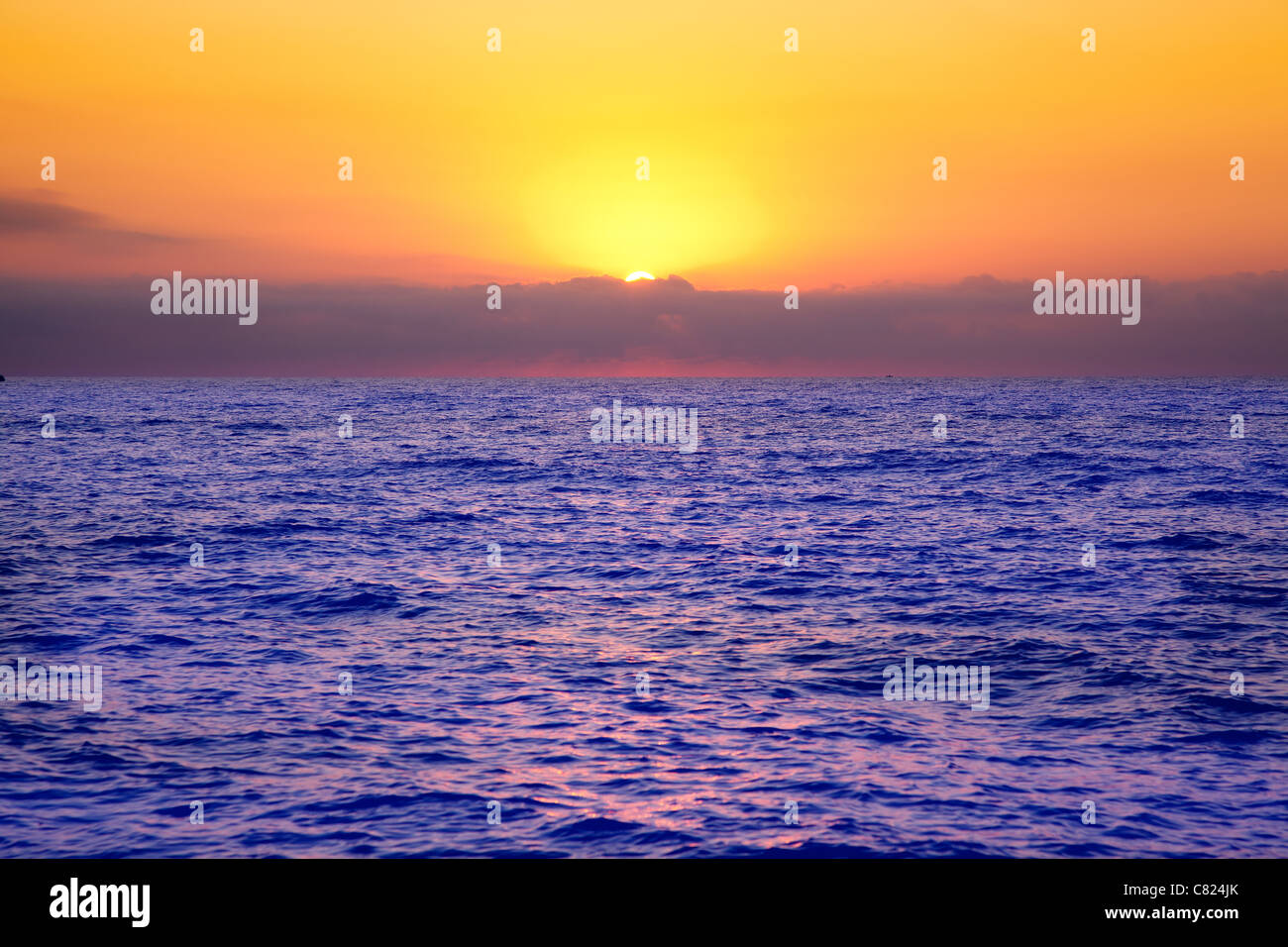 Mediterranean sea sunrise with orange sky and purple ocean Stock Photo