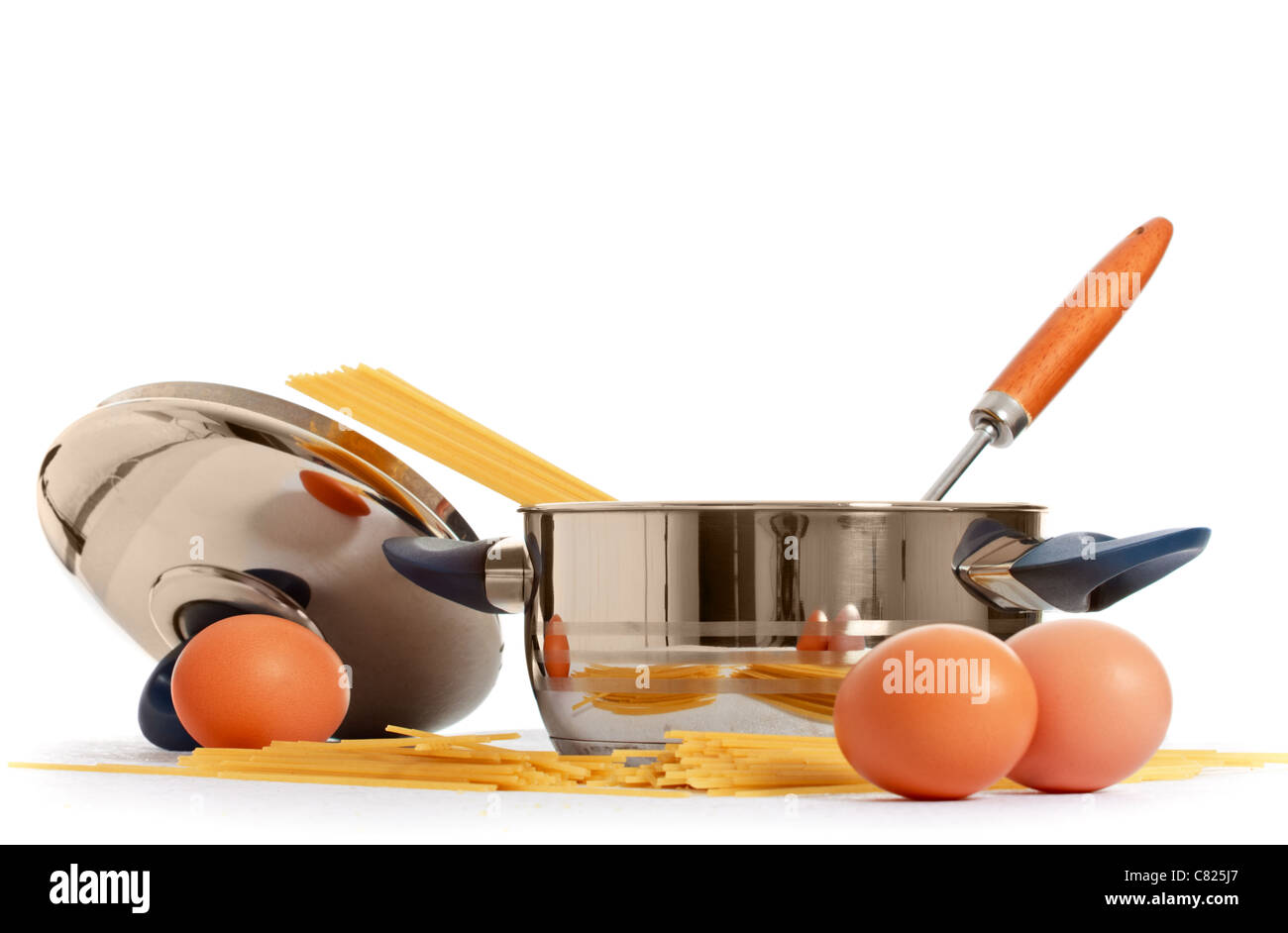 spaghetti, eggs and kitchen utensil on white background Stock Photo