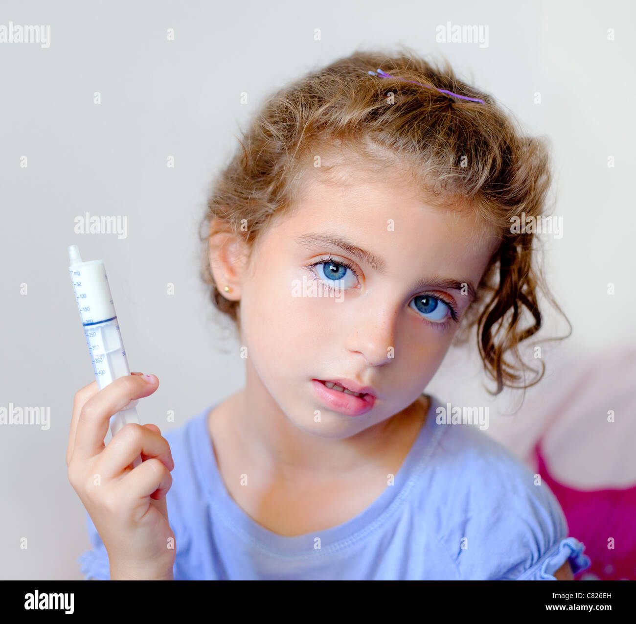 almost happy children kid girl with syringe of antibiotic medicine
