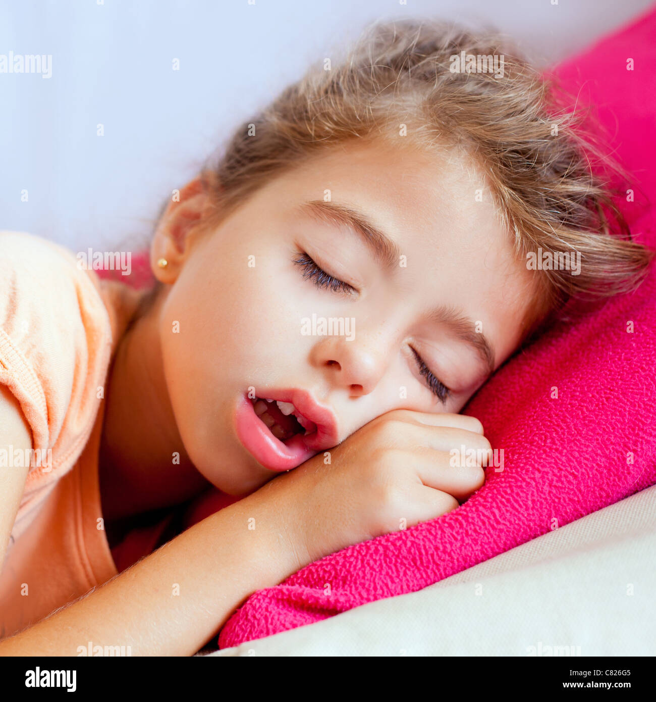 Deep sleeping children girl closeup portrait on pink pillow Stock Photo