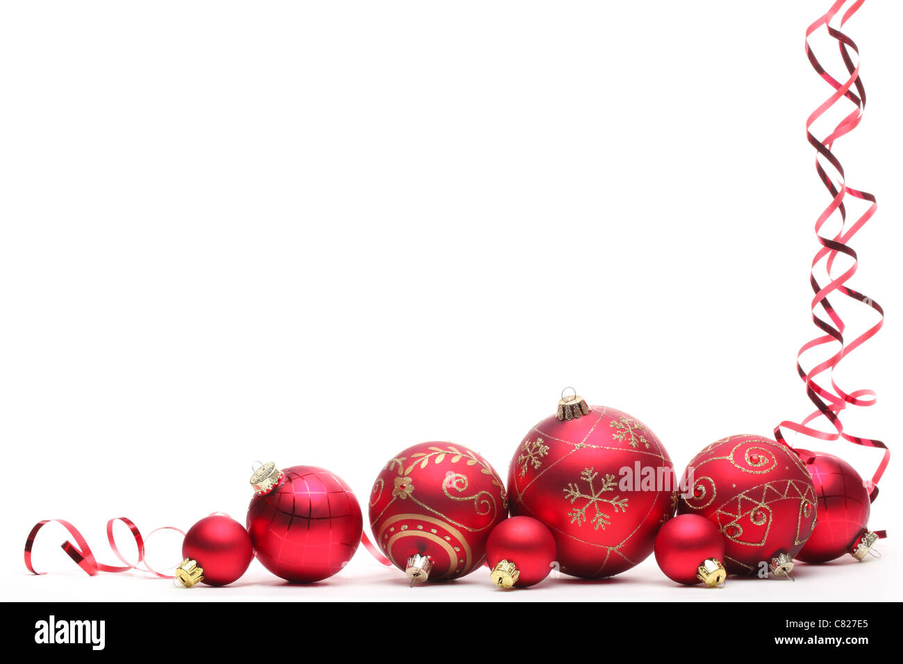 Red Christmas balls with ribbons isolated on white Stock Photo - Alamy
