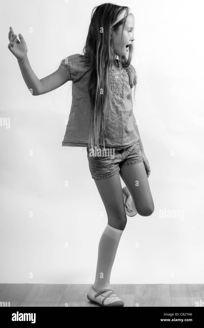 8 year old girls dancing in shorts and T-shirt Stock Photo - Alamy
