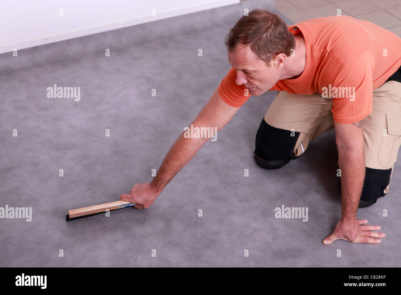 Man renovating the floor Stock Photo