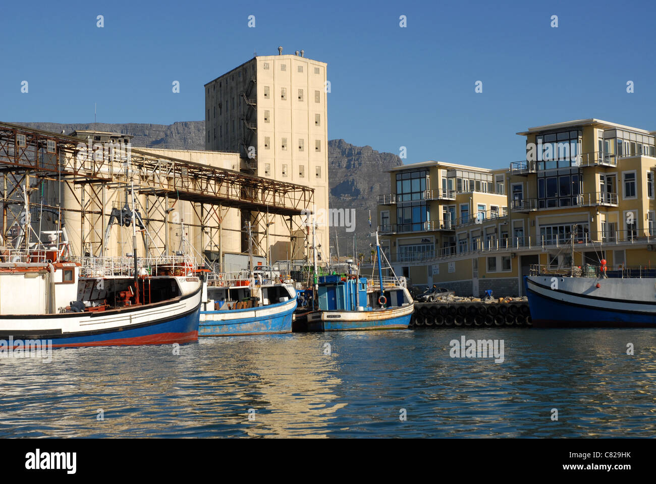 fishing boats, warehouse and apartments, Cape Town, Western Cape, South Africa Stock Photo