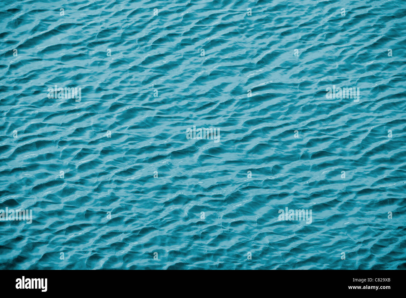Blue sea water surface background Stock Photo - Alamy