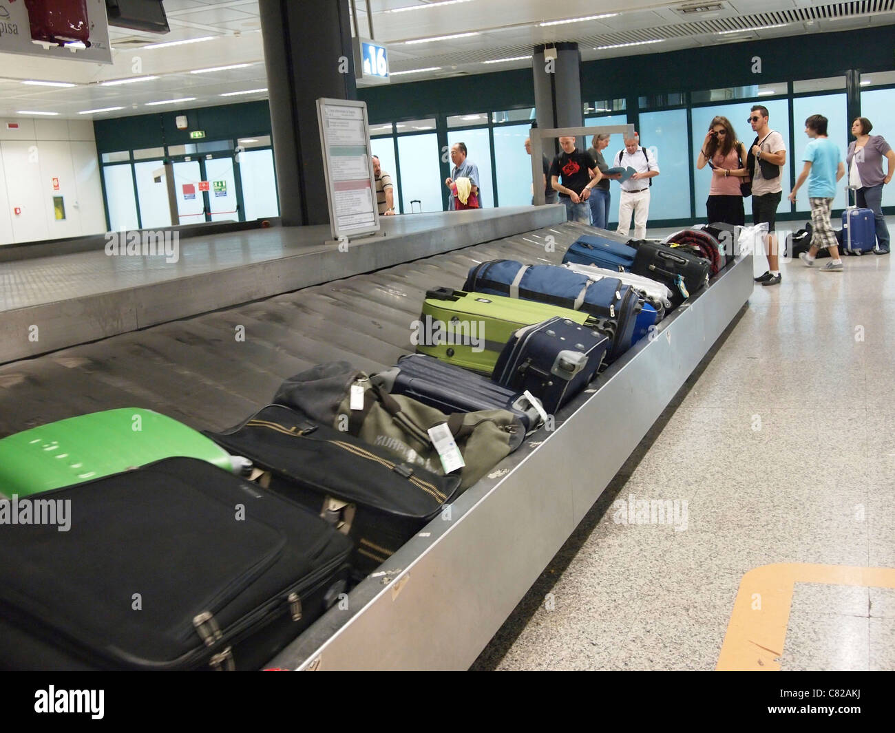 Waiting for luggage and suitcases at a baggage carousel claim, Fiumicino Airport, Rome, Italy Stock Photo