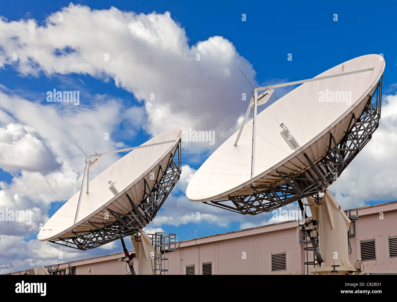 Satellite TV antenna on the roof of communication center Stock Photo