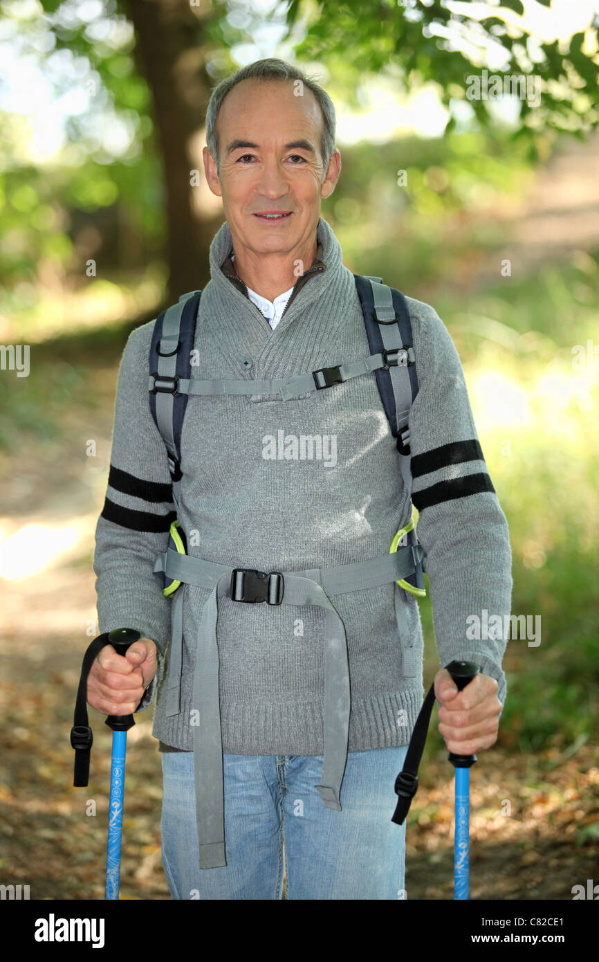 Senior man walking with poles Stock Photo - Alamy