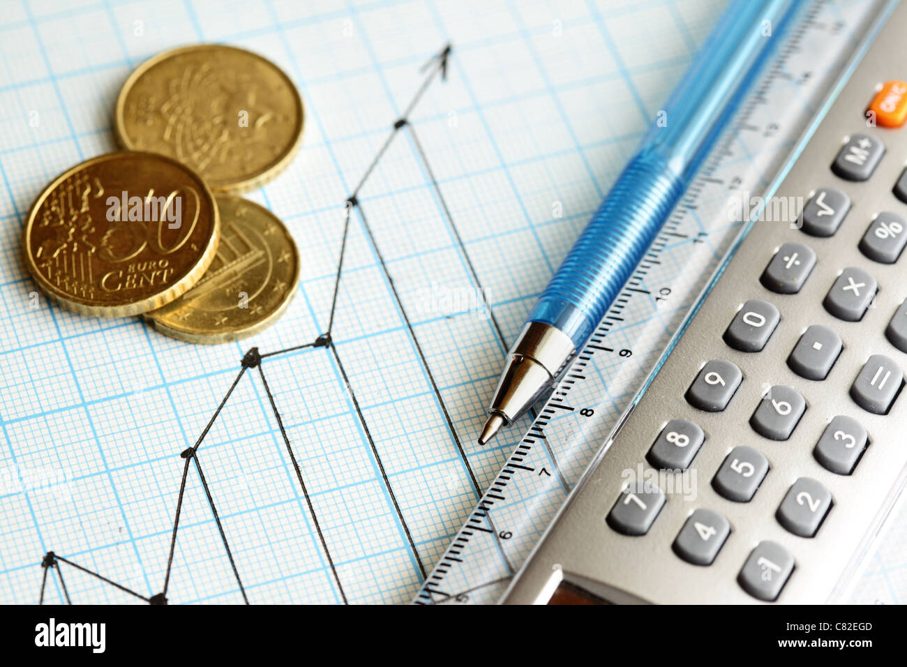 Business still-life with coins, pen and calculator Stock Photo