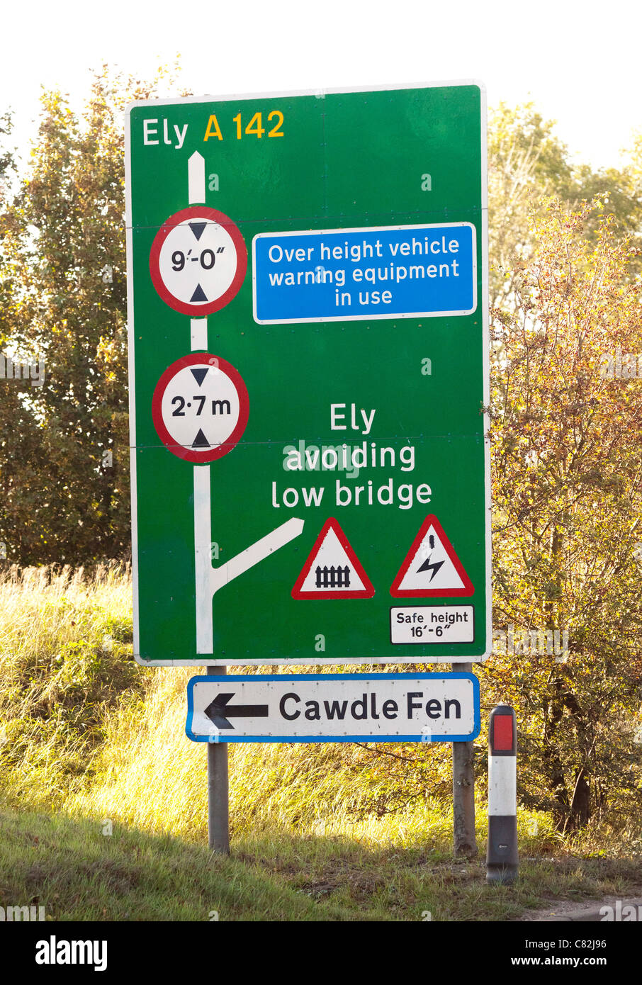 sign warning of height restrictions of low bridge ahead Stock Photo