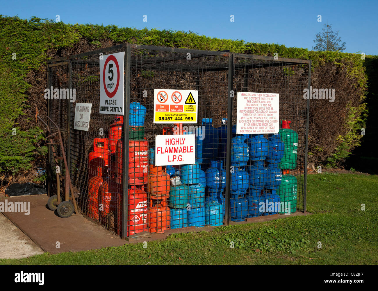 gas bottles / cylinders stored securely in a cage in UK Stock Photo