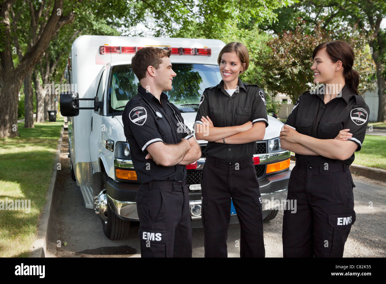 Group of 3 EMS workers standing in front of ambulance visiting Stock Photo Alamy