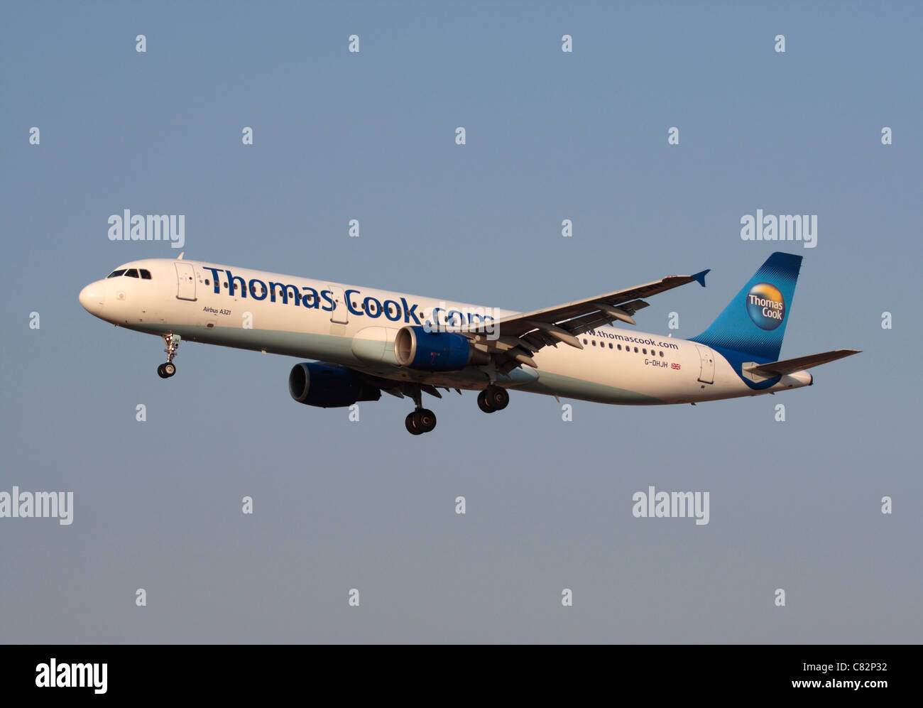 Thomas Cook Airlines Airbus A321 on approach against a clear blue sky Stock Photo