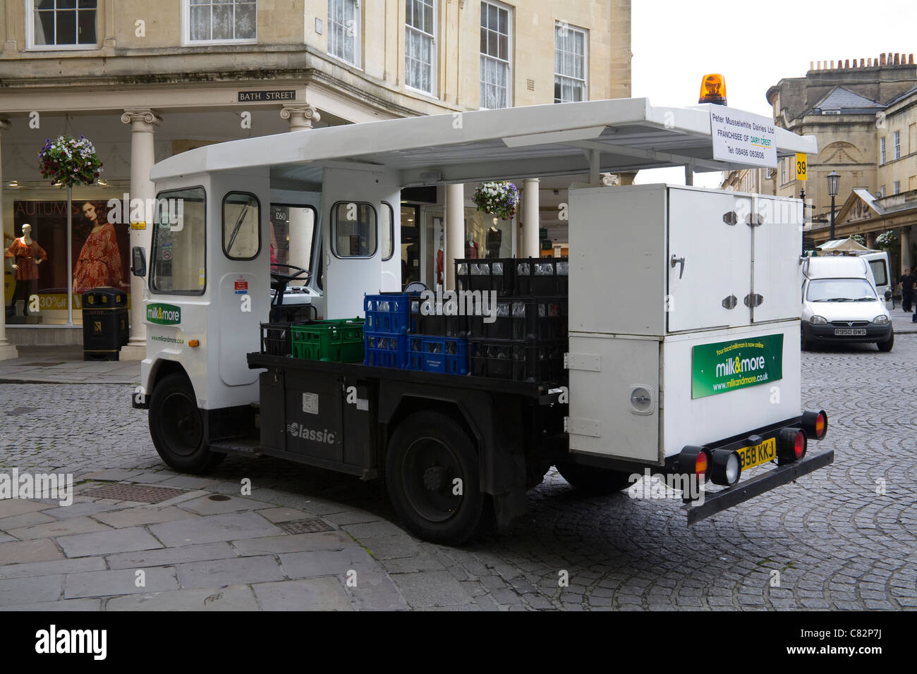 England UK Electric milk float on the cobbled street of a historic city ...