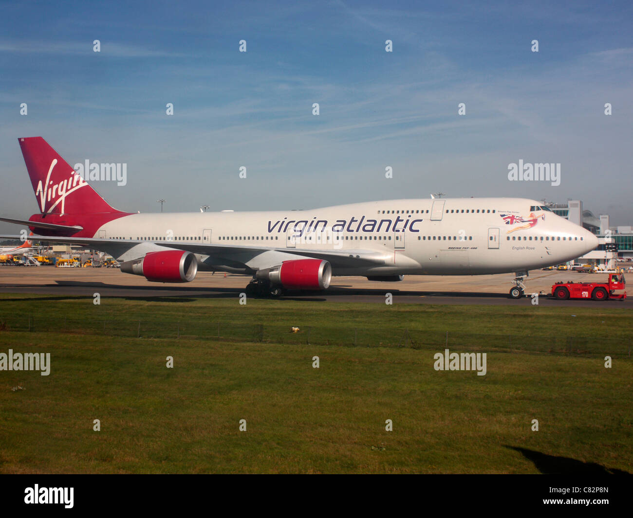 Air travel and the environment. Virgin Atlantic Airways Boeing 747-400 at Gatwick Airport under tow as an alternative to taxiing under its own power Stock Photo