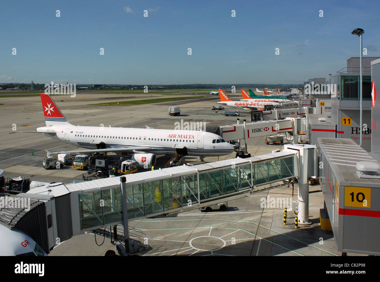 Many aircraft parked on the ground at Gatwick Airport. Jet plane planes air travel transport Stock Photo