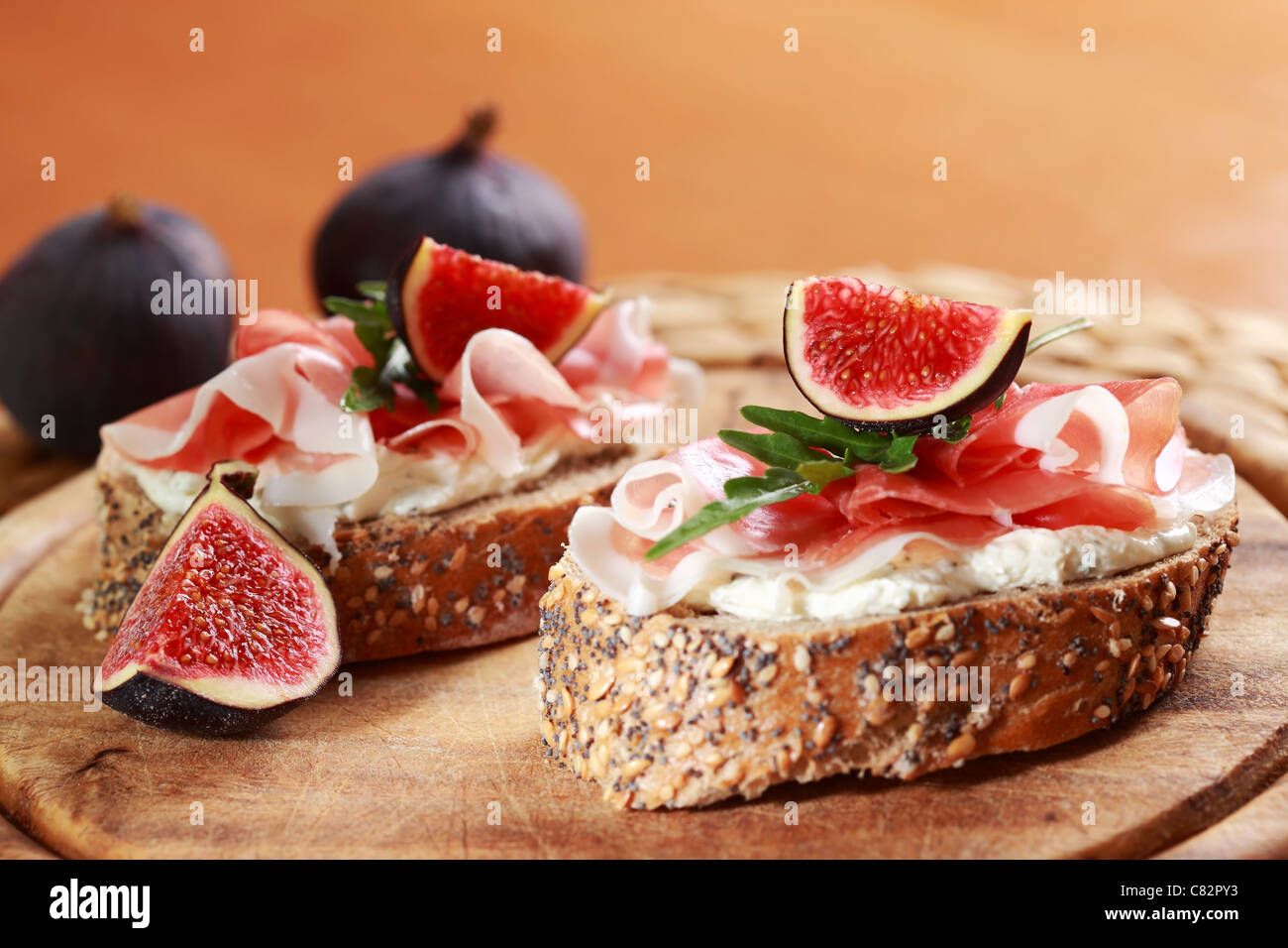 Sandwich with cream cheese, prosciutto, fig and rocket Stock Photo Alamy