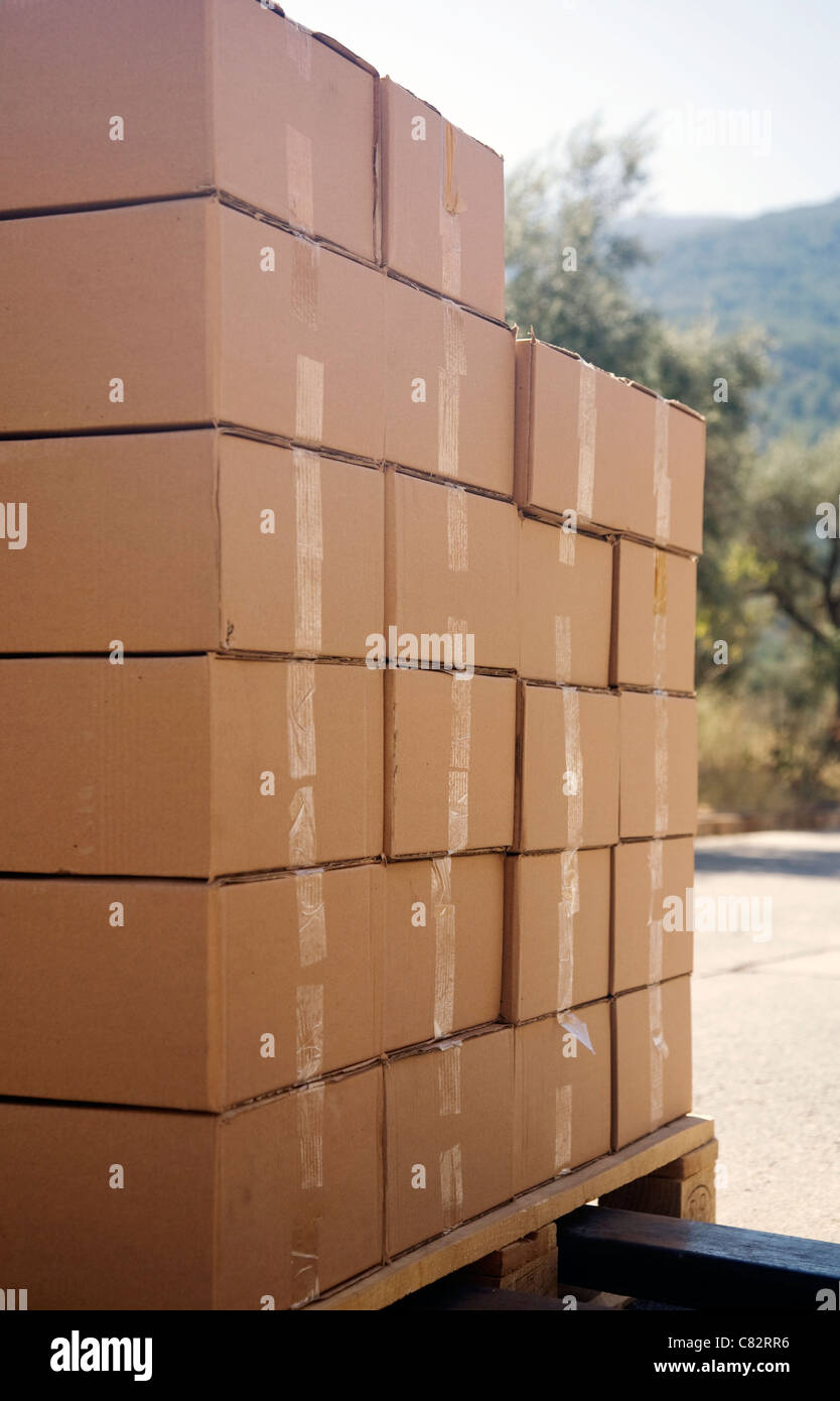 Download Boxes Stacked On A Wooden Pallet With A Forklift About To Carry Them Stock Photo Alamy