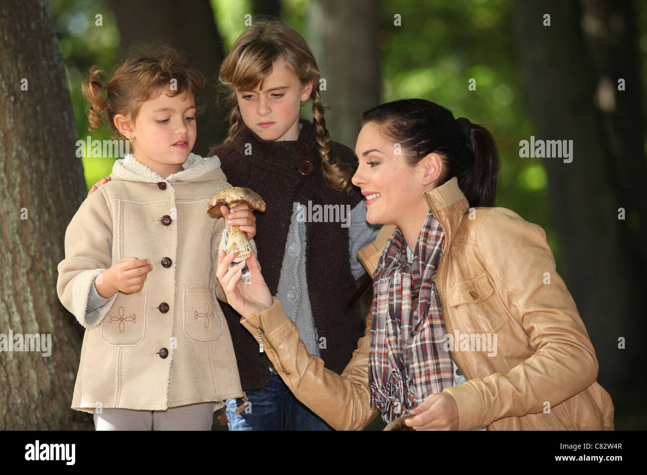 Mother in woods with two daughters Stock Photo