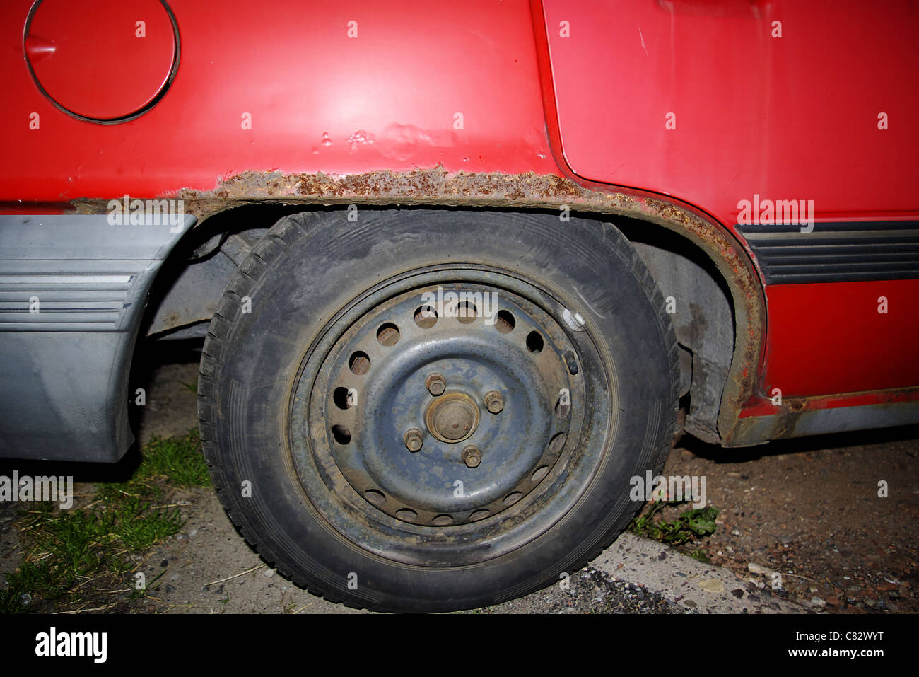 corrosion on a car mudguard, rusty car Stock Photo