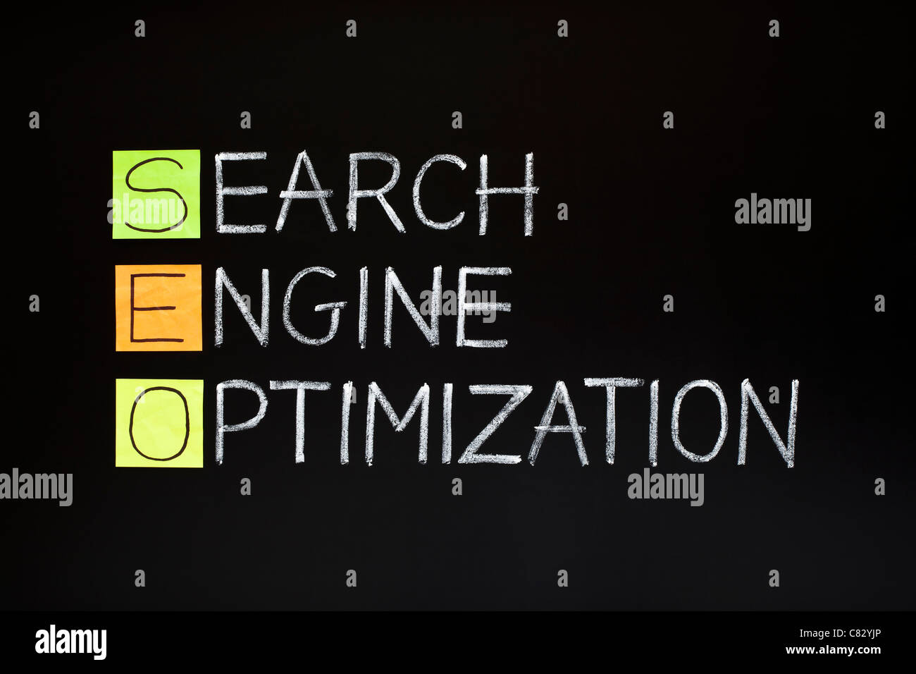 SEO acronym - SEARCH ENGINE OPTIMIZATION made with sticky notes and white chalk on a blackboard Stock Photo