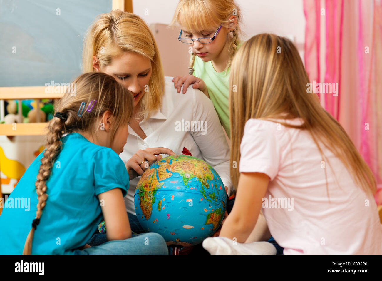Family affairs - mother explaining the world to her children; presumably she is a teacher Stock Photo