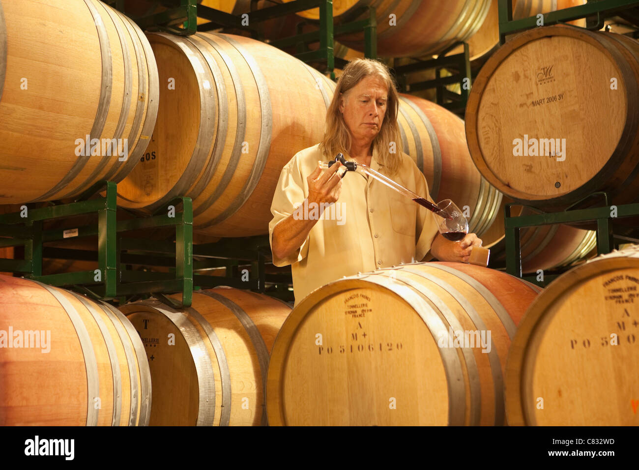 vintner David Hopkins samples a recent vintage using a wine thief, Bridlewood Winery, Santa Ynez Valley, California Stock Photo