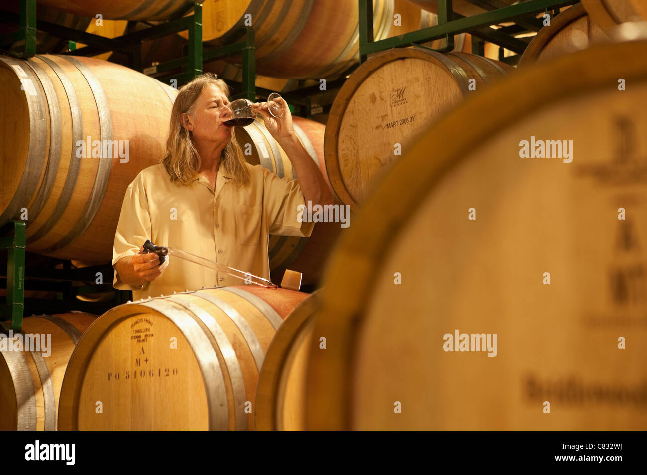 vintner David Hopkins samples a recent vintage using a wine thief