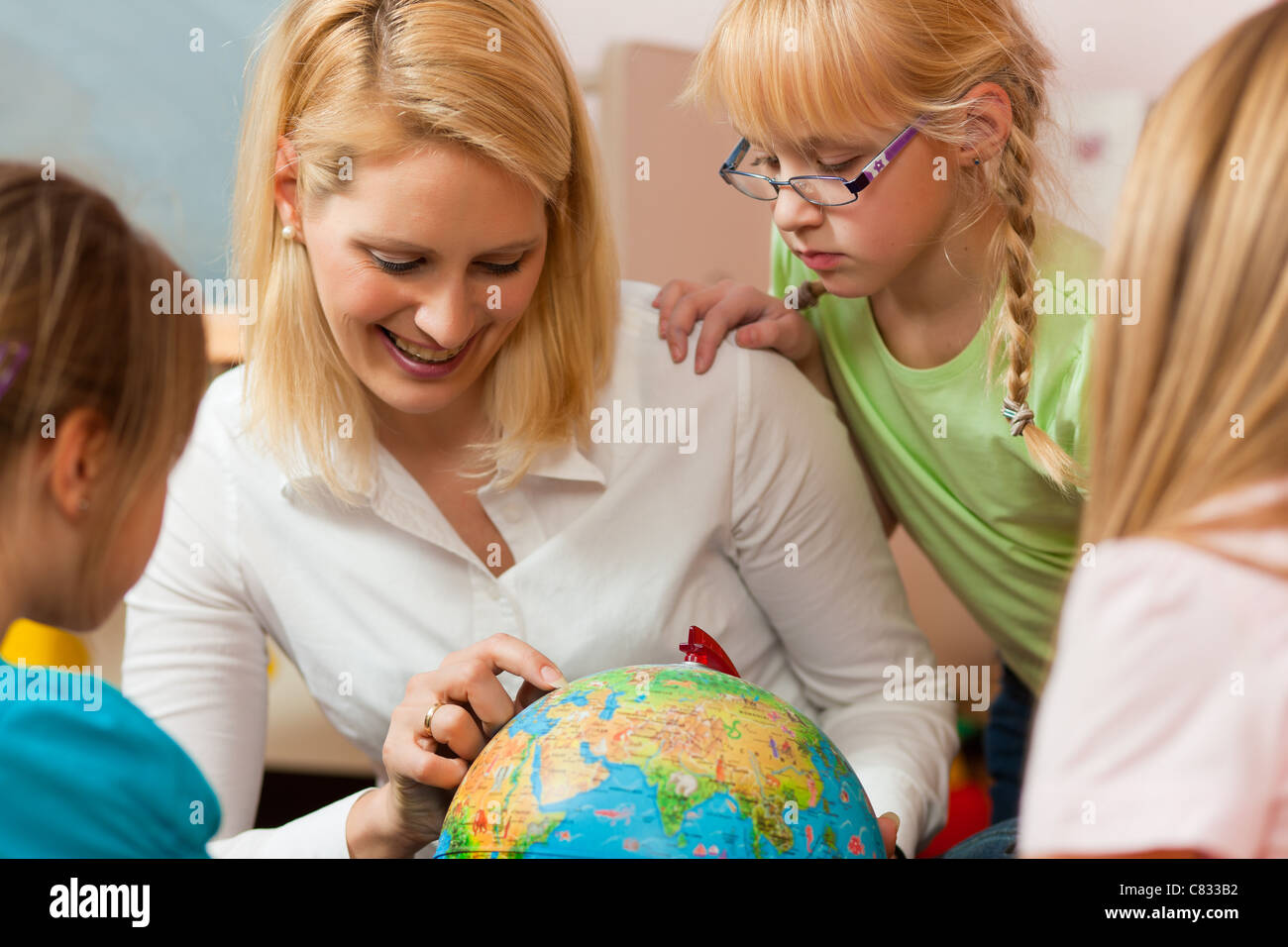 Family affairs - mother explaining the world to her children; presumably she is a teacher Stock Photo
