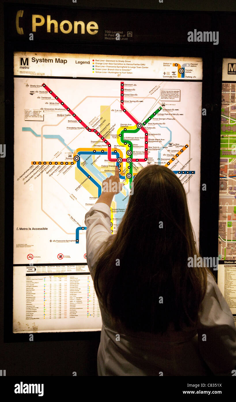 A Young Woman Looking At A Map Of The Metro Subway System Metro