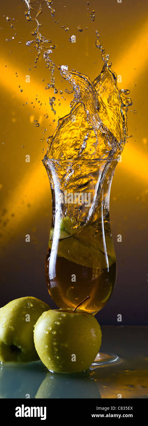 green apples and glass with juice on a glass table Stock Photo - Alamy