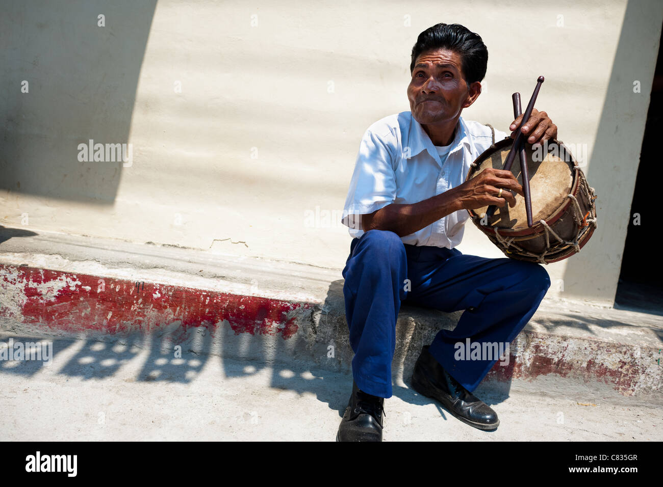 A Salvadoran man plays a drum during the procession of the Flower & Palm Festival in Panchimalco, El Salvador. Stock Photo