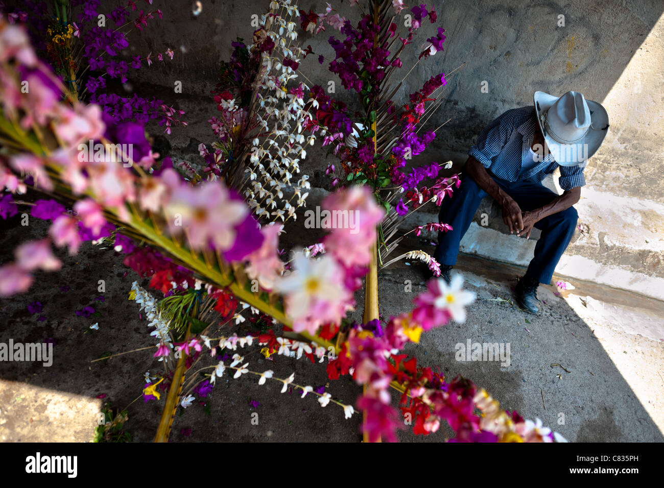 A Salvadoran cowboy rests during the Flower & Palm Festival in Panchimalco, El Salvador. Stock Photo