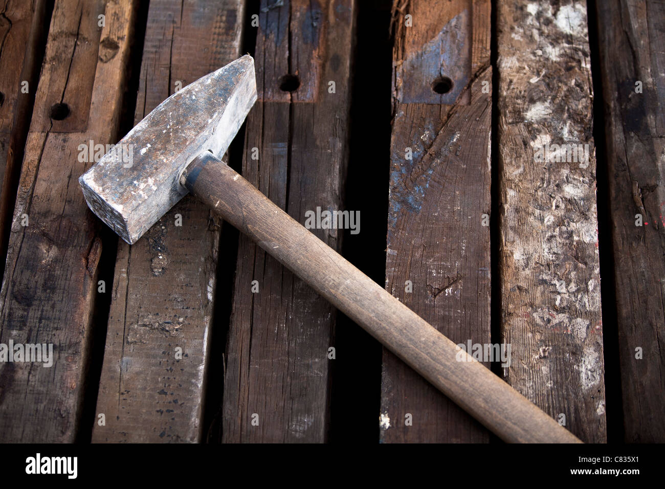 Hammer laying on the wooden beams Stock Photo