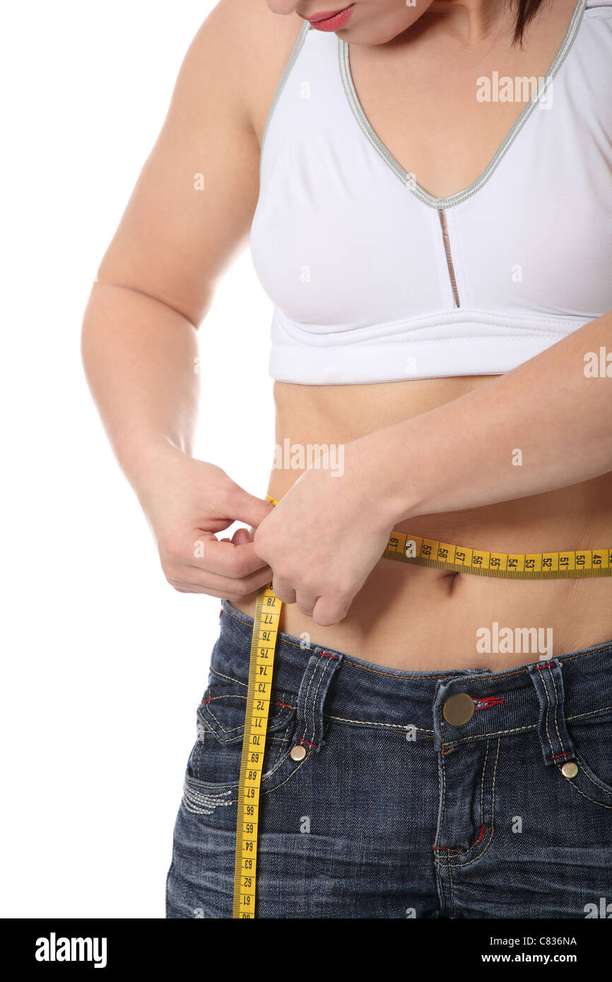 Middle aged woman measuring her circumference with tape measure Stock