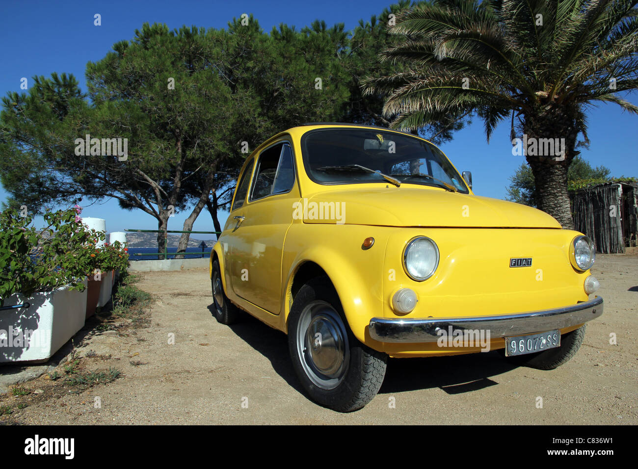 bright yellow Fiat 500 cinquecento at seaside Sardinia Sardegna Italy Stock Photo