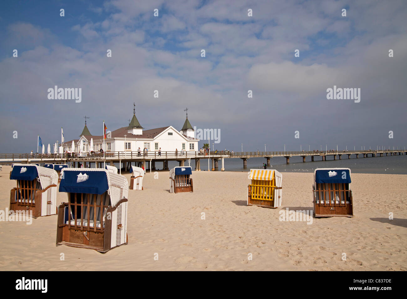Beach chairs ' Strandkorb ' and  Seebruecke or Pier at the baltic beach of the seaside resort Ahlbeck, Usedom island,  Germany Stock Photo