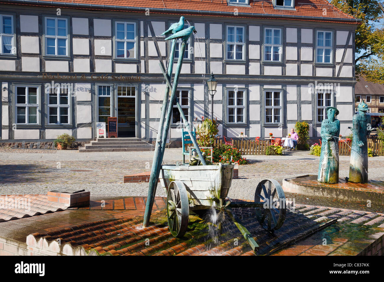 Market Place with fountain and sculptures by Christian Uhlig, Angermuende, Brandenburg, Germany Stock Photo