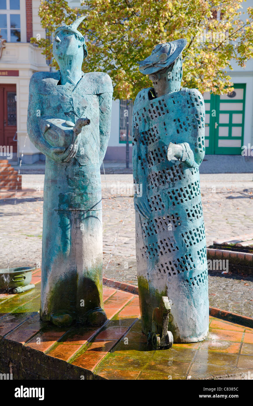 Figures from the fountain and sculptures by Christian Uhlig on the Market Place, Angermuende, Brandenburg, Germany Stock Photo