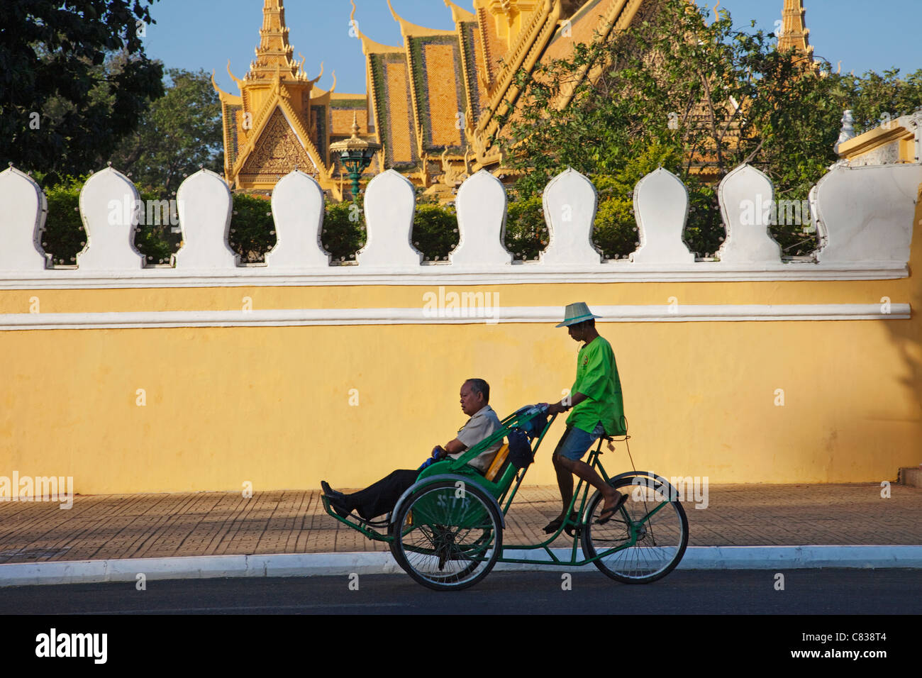 Cambodia, Phnom Penh, Cyclo in front of The Royal Palace Stock Photo