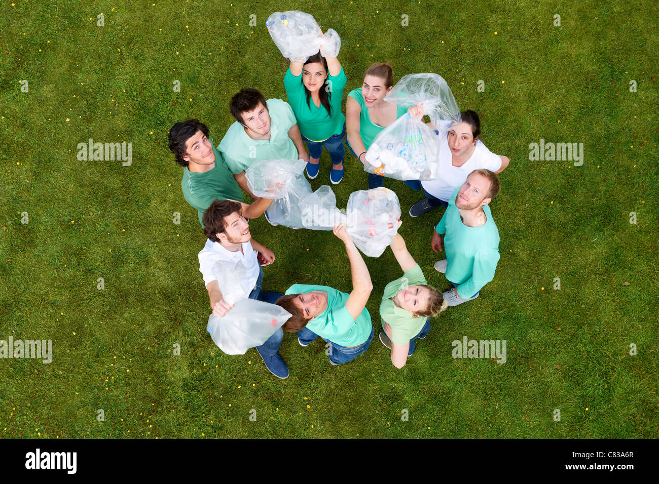 People holding garbage bags on grass Stock Photo