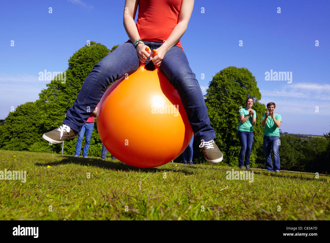 Teams racing on exercises balls Stock Photo