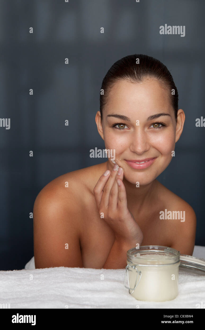 Woman scrubbing her face with sugar Stock Photo