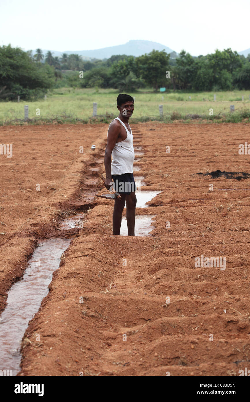 man working to open an irrigation channel Andhra Pradesh South India