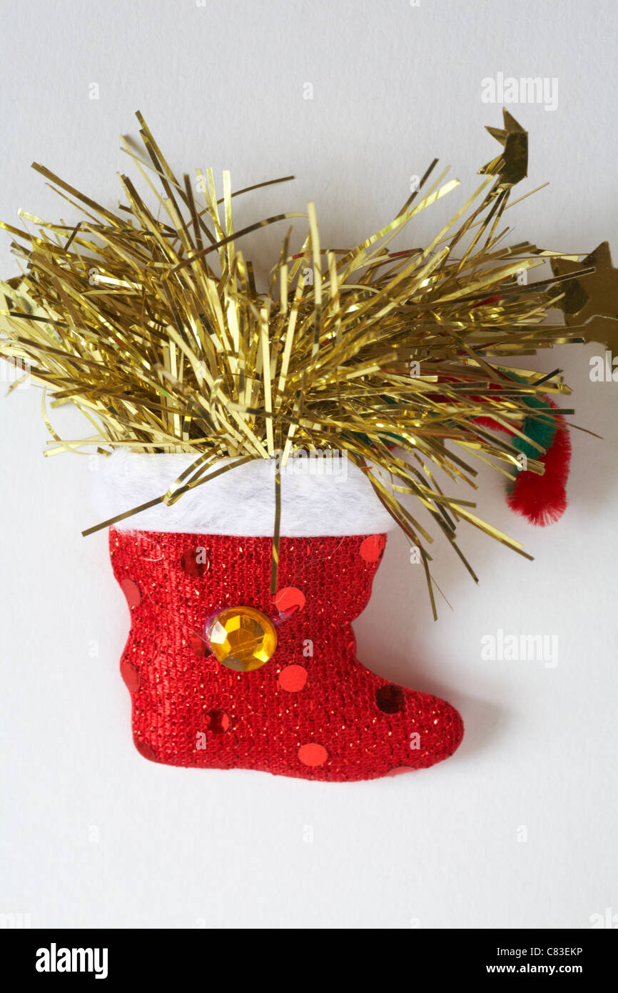 Christmas stocking with tinsel novelty flashing light brooch isolated on white background Stock Photo