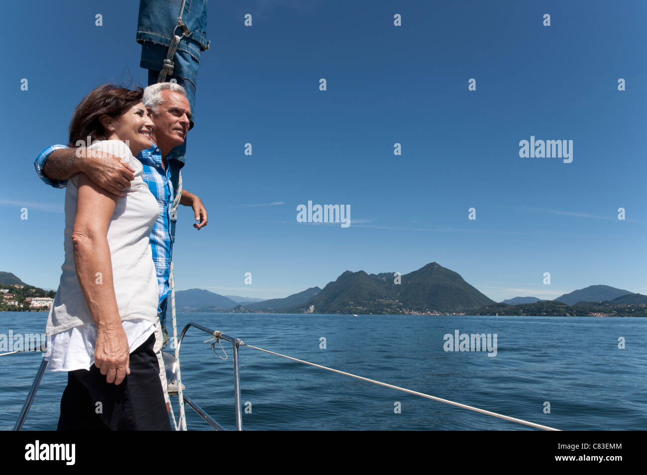 Older couple standing on boat together Stock Photo