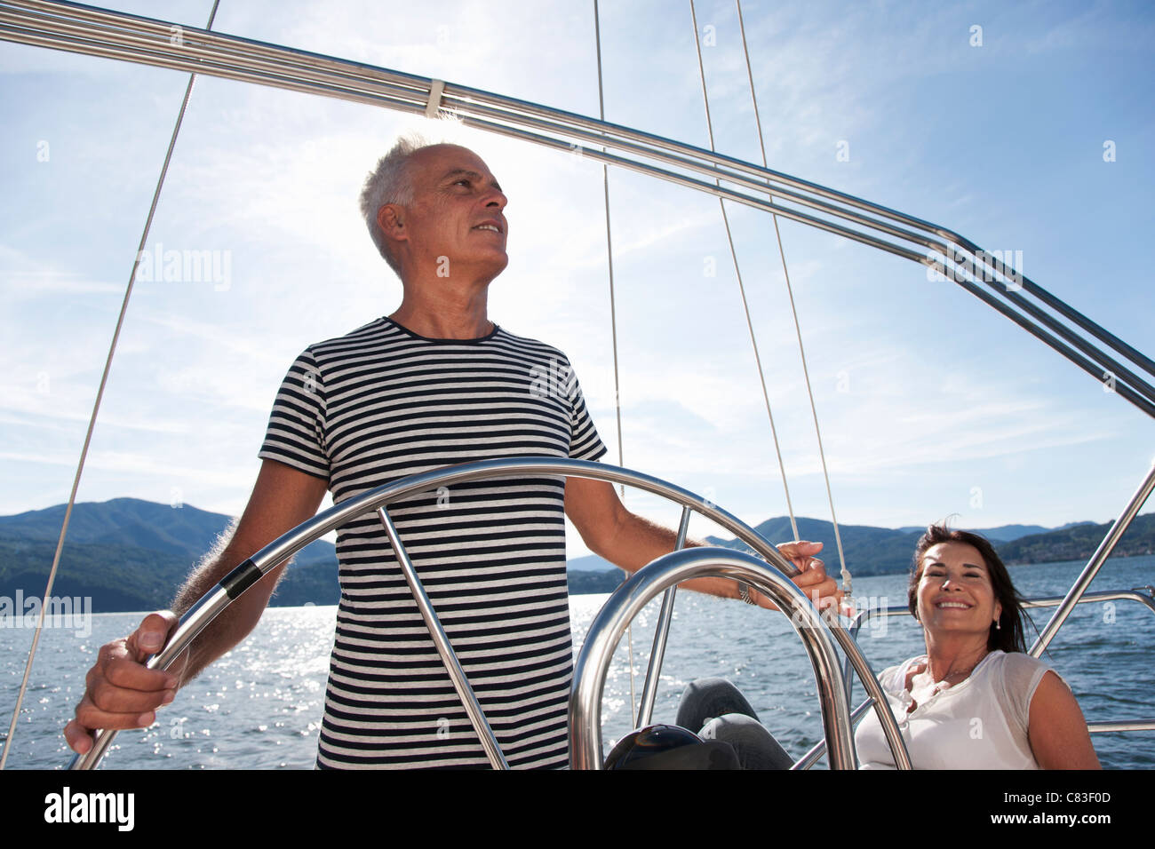 Older couple relaxing on sailboat Stock Photo