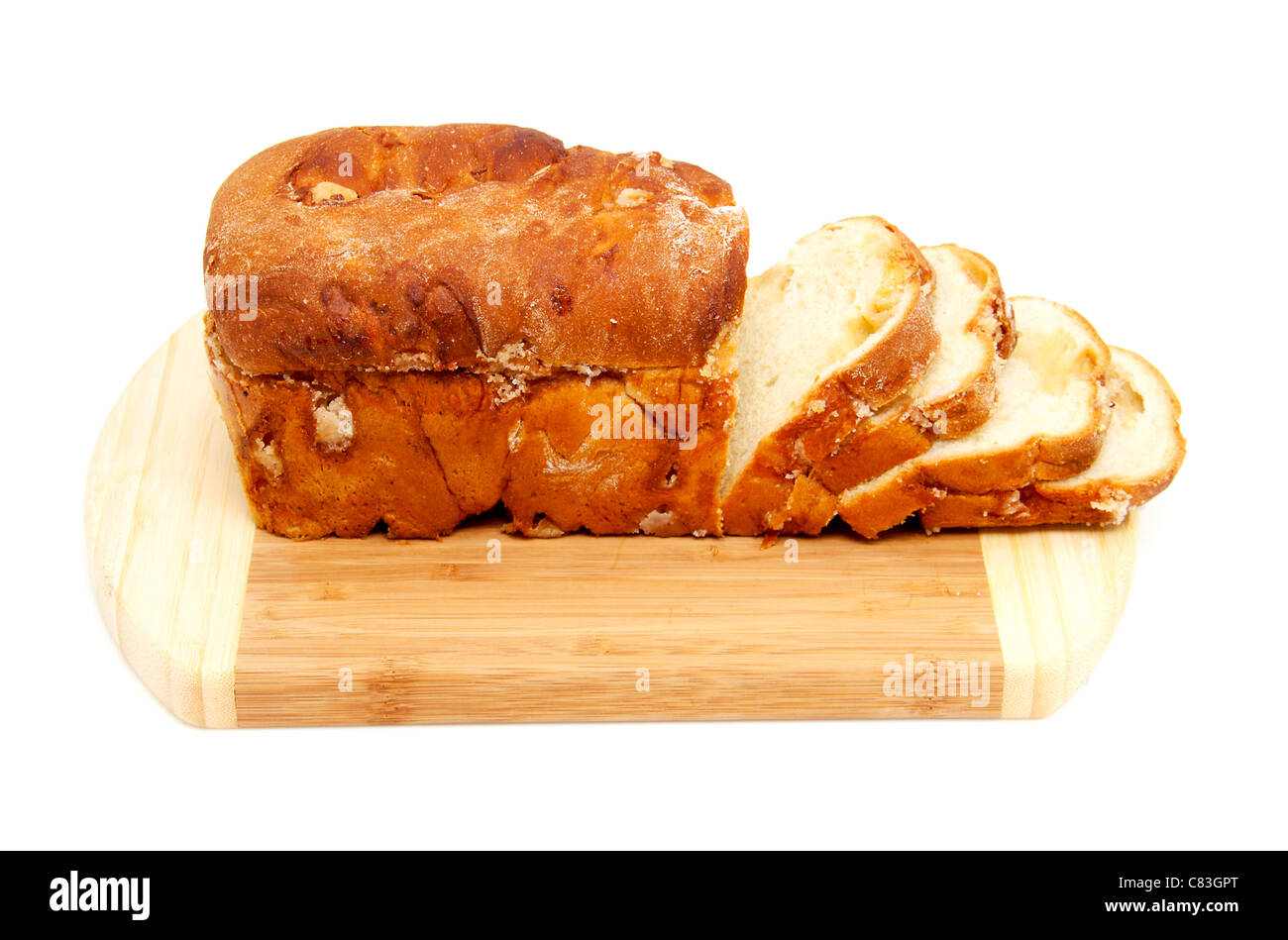 baked sugar bread in closeup on wooden cutting board over white background Stock Photo